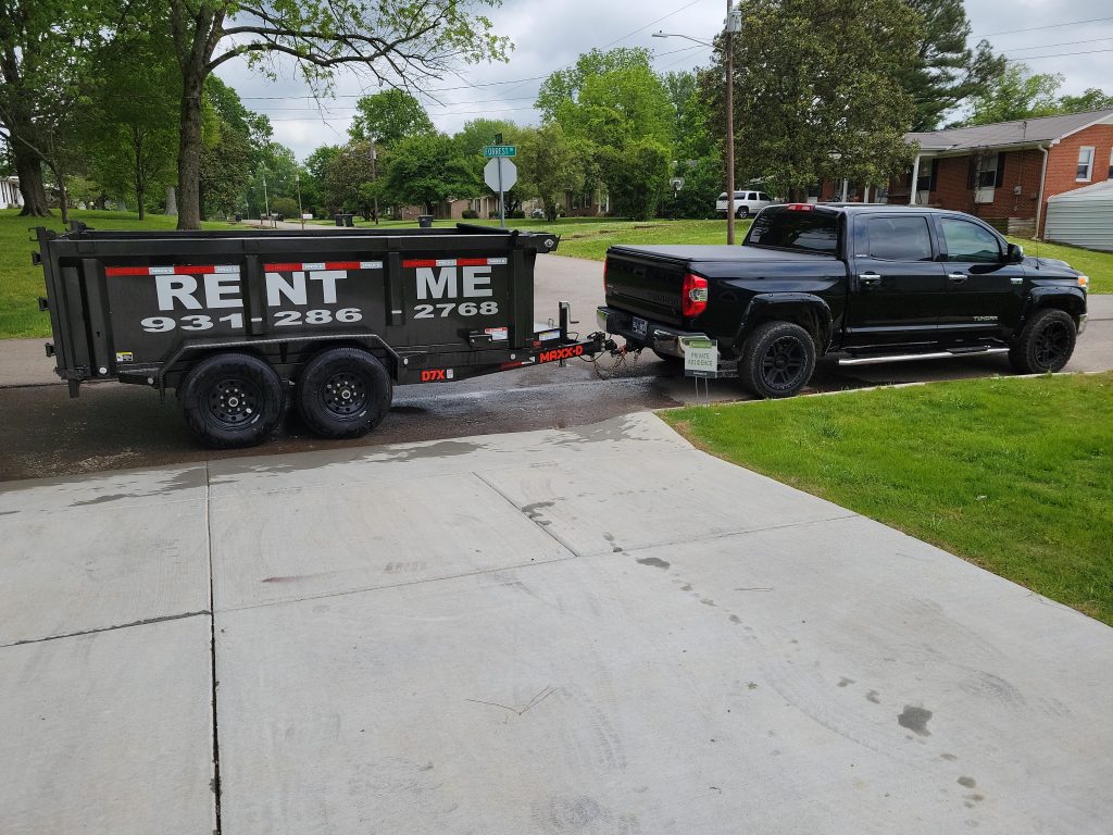 dumpster rental Spring Hill TN being pulled behind a truck